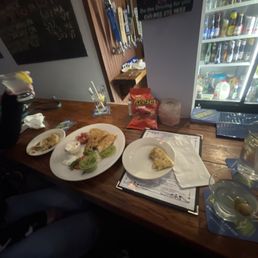 a table with plates of food and drinks a table with plates of food and drinks
