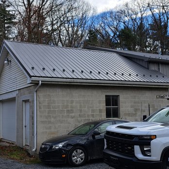 Lion Country Contracting - two vehicles parked in front of a building - Roofing Near Me Lion Country Contracting - two vehicles parked in front of a building - Roofing Near Me