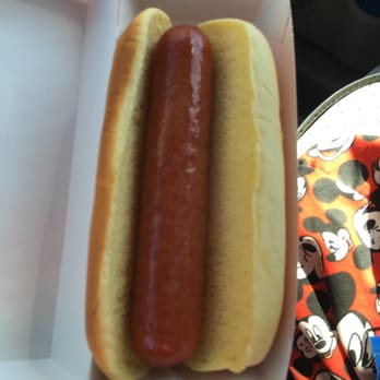 7-Eleven - a person holding a hot dog in a bun - Gas Stations Near Me - Vancouver, Washington