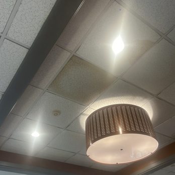 IHOP - Nasty unknown liquid and stuff falling / ooooozzzing from the dark stained, fuzzy, liquid soaked tiles. - Breakfast & Brunch Near Me - KINGSLAND, Georgia