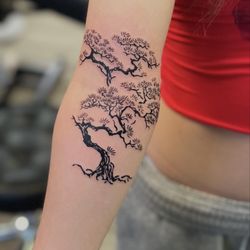 Beauty is Pain - Delicate blackwork tree design wrapping the arm, featuring flowing branches and fine detailing. Clean, minimal, and naturally elegant. Roxie
