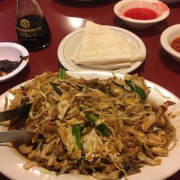 a plate of noodles with meat and vegetables