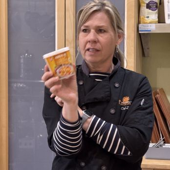 Pans on Fire - Laura showing us the recommended Curry Paste. - Cooking Classes Near Me - Pleasanton, California