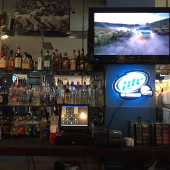 Tailgate Tavern - a bar with a television and liquor bottles - American Near Me - Arlington, Texas