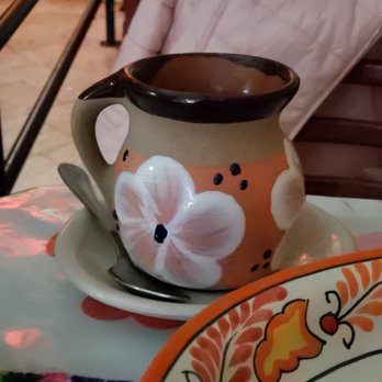 Metate - a coffee cup and plate on a table - Mexican Near Me - Yonkers, New York