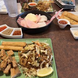 Kusina Cuisine - Pork belly with pancit and lumpia, shrimp chips, dynamite lumpia, chicken skewers with lumpia and pancit.