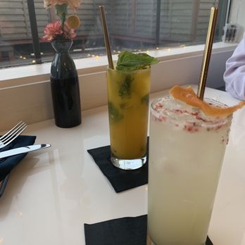 VIM Dining & Desserts - Grapefruit cocktail adorned with petals; mango mojito - New American Near Me - Santa Cruz, California