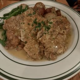 Veal francaise with roasted potatoes and vegetables.