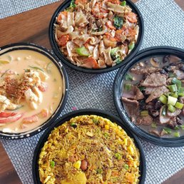three bowls of food on a table