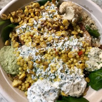 Mezeh - Bowl with different hummuses, feta dip, corn, Couscous, spinach, chicken shawarma, and brown basmati rice with tahini and harissa sauce. - Halal Near Me - Springfield, Virginia