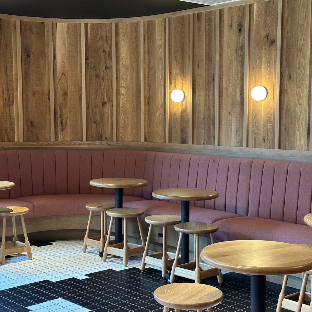 Alcove seating area in front of coffee counter, by back entance