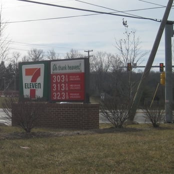 7-Eleven - a gas station with a gas station sign in the foreground - Convenience Stores Near Me - Gainesville, Virginia