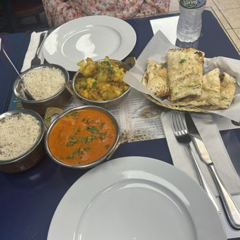 Indian Express Cuisine - a plate of rice, a bowl of curry, and a bowl of naan bread - Indian Near Me - Levittown, New York