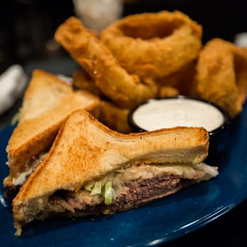 Mojo Old City BBQ - The reuben with a side of onion rings. - Barbeque Near Me - St. Augustine, Florida