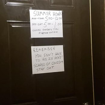 Prairie Dust Bar - a door with a sign on it - Nightlife Near Me