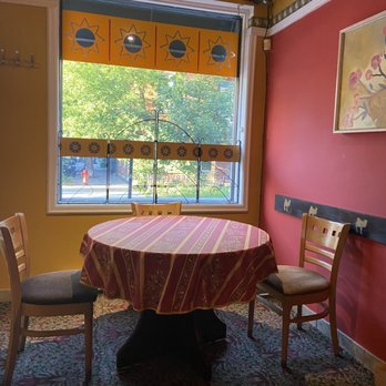 Au-Tarot - a dining room with a table and chairs - Mediterranean Near Me - Montreal, Quebec Au-Tarot - a dining room with a table and chairs - Mediterranean Near Me - Montreal, Quebec