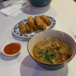 Ledu Restaurant - Mohinga (fish and rice noodle stew) and (in the back) samosa wrapped egg roll style