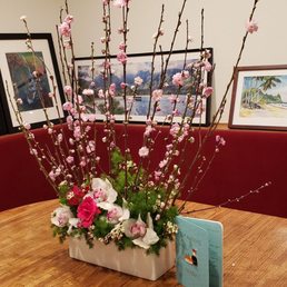 Flowering peach branches, roses, and cymbidium orchids Flowering peach branches, roses, and cymbidium orchids