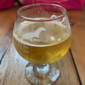 Zipline Brewing - a glass of beer on a wooden table - Breweries Near Me - Omaha, Nebraska