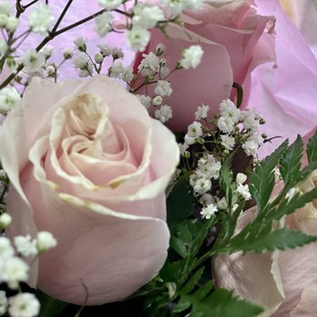 Henry's Florist - Also, these were delivered the Monday after Mother's Day. - A floral arrangement featuring pink roses, white baby's breath, and green foliage, arranged with pink tissue paper in the background. - Florists Near Me - Brooklyn, New York