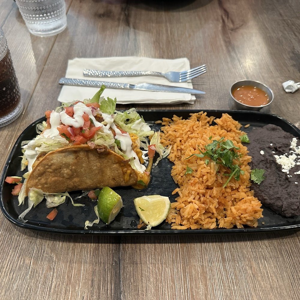 Two beef tacos with refried black beans and rice Two beef tacos with refried black beans and rice