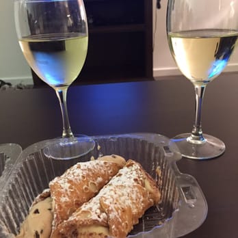 Bova's Bakery - Cappuccino cannoli on the left and creme brûlée cannoli on the right. (Wine not included, but a good pair to the pastries haha) - Bakeries Near Me - Boston, Massachusetts