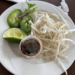 Pho accompaniments (forgot to take picture BEFORE plucking basil and squeezing lime)