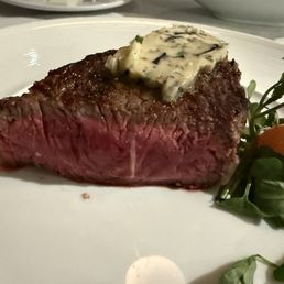 Perfectly cooked medium rare New York strip (half of split plate)