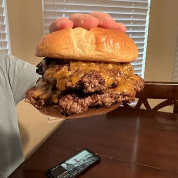 Pepper's Street Food - a man holding a cheeseburger - Food Trucks Near Me - Melbourne, Florida Pepper's Street Food - a man holding a cheeseburger - Food Trucks Near Me - Melbourne, Florida