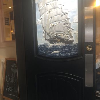 Harbor House Northport - Sailboat/ship engraving and painting on entrance door - American Near Me - Northport, New York