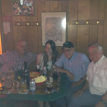 West End Tavern - a group of people sitting around a table - Bars Near Me - Findlay, Ohio