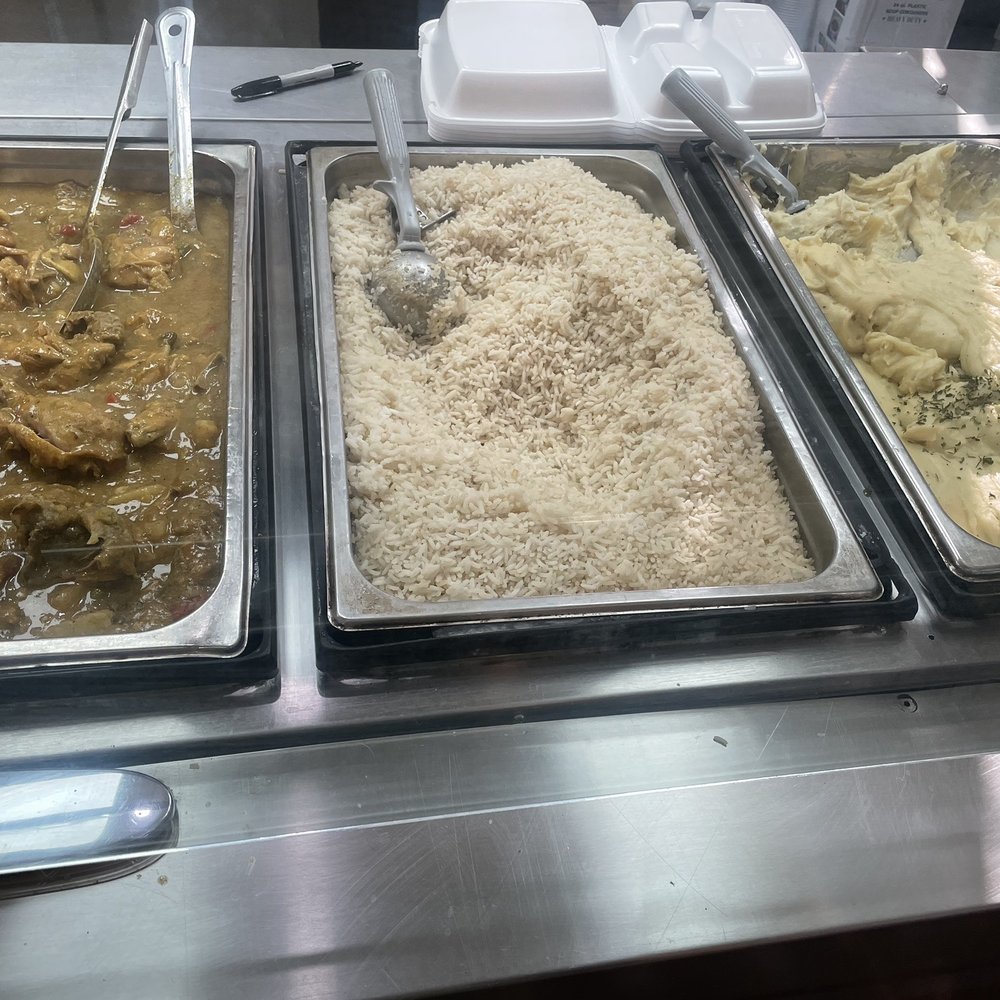 Mikki's Soul Food Cafe - I think that's Smothered Pork Chops, rice and mashed potatoes. - Soul Food Near Me - Houston, Texas