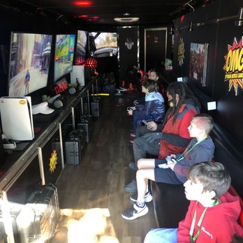 Optimum Mobile Gaming - 4 massive tvs with 4 different systems and a gaming chair all built inside. A gamers dream! - Game Truck Rental Near Me Optimum Mobile Gaming - 4 massive tvs with 4 different systems and a gaming chair all built inside. A gamers dream! - Game Truck Rental Near Me