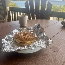 Breakfast sandwich on a bagel with egg & bacon.