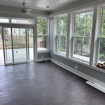 Bowman Renovations - a sunroom with sliding glass doors - General Contractors Near Me