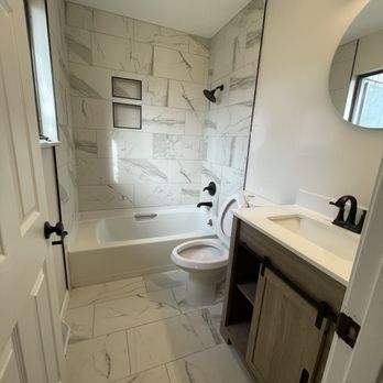A+ Mechanicals -  a bathroom with a toilet, sink, and tub - Electricians Near Me - Champaign, Illinois
