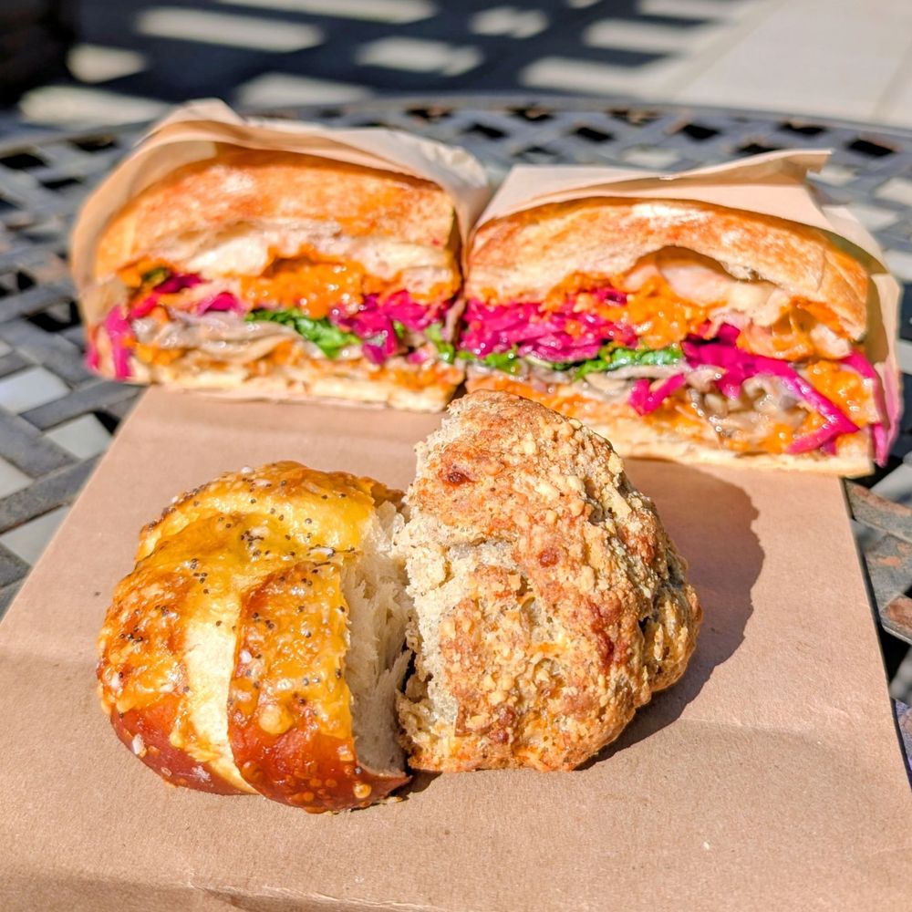 Cheddar lye roll, parmesan biscuit, and roasted mushroom sandwich in the back