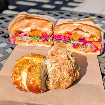 Sea Wolf Bakers - Cheddar lye roll, parmesan biscuit, and roasted mushroom sandwich in the back - Bakeries Near Me - Seattle, Washington Sea Wolf Bakers - Cheddar lye roll, parmesan biscuit, and roasted mushroom sandwich in the back - Bakeries Near Me - Seattle, Washington