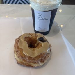Coffee cream Cronut and cold brew pistachio sweet cream coffee