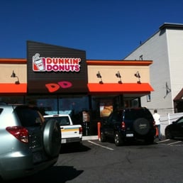  cars parked in front of a dunkin donuts store