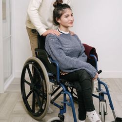 Bethel Place Assisted Living - Assisting our residents safely transfer from bed to wheelchair and ensuring they are comfortable and happy