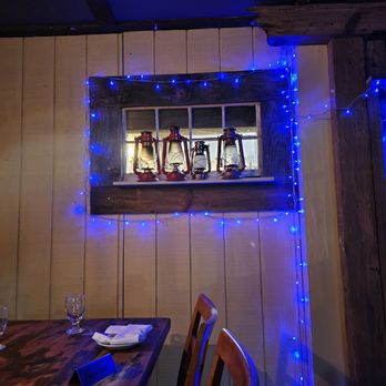 The Old Mill - a window decorated with blue lights - New American Near Me - Roxbury, New York