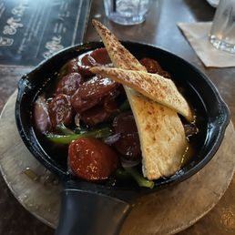 Their signature appetizer:  Spanish Chorizo in White Wine...juicy caramelized, Spanish chorizo, sautéed in garlic butter, and white wine.