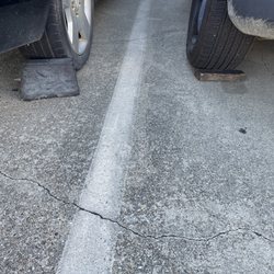 Eagle Transmission & Auto Repair - Vehicle over 20 years old properly secured with a rubber stop.  Mine secured with a wooden post.  I could barely get inside.