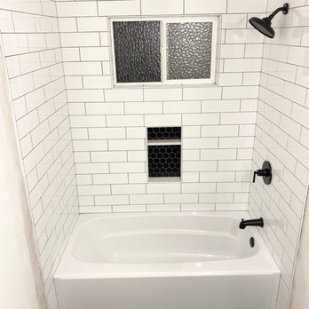 Superior Tile Design - a bathtub with a window - General Contractors Near Me - Fair Oaks, California