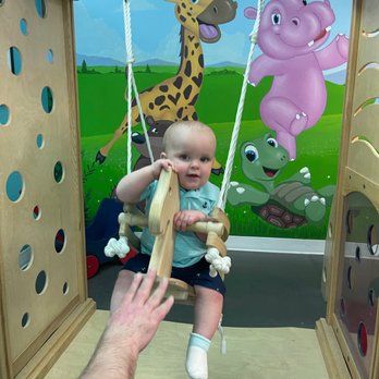 Room to Bloom - My 1 yr old playing on the swing in the indoor playground - Venues & Event Spaces Near Me - Beverly, Massachusetts Room to Bloom - My 1 yr old playing on the swing in the indoor playground - Venues & Event Spaces Near Me - Beverly, Massachusetts