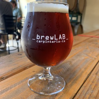brewLAB - a glass of beer on a wooden table - Breweries Near Me - Carpinteria, California