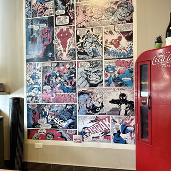 Hermosa - a coca cola machine in front of a wall covered with comics - Burgers Near Me - Chicago, Illinois Hermosa - a coca cola machine in front of a wall covered with comics - Burgers Near Me - Chicago, Illinois