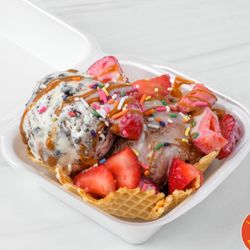 Sol Dias - Two scoops of SolDias Ice Cream with fresh-cut strawberries, cajeta, lechera, and sprinkles served on a homemade waffle bowl.