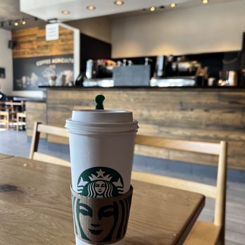 Starbucks - a starbucks cup on a wooden table - Coffee & Tea Near Me - Schertz, Texas Starbucks - a starbucks cup on a wooden table - Coffee & Tea Near Me - Schertz, Texas